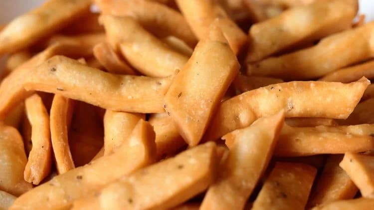 Close-up of crispy Namak Pare showing the diamond-cut pieces, blistered surface and flecks of seasoning