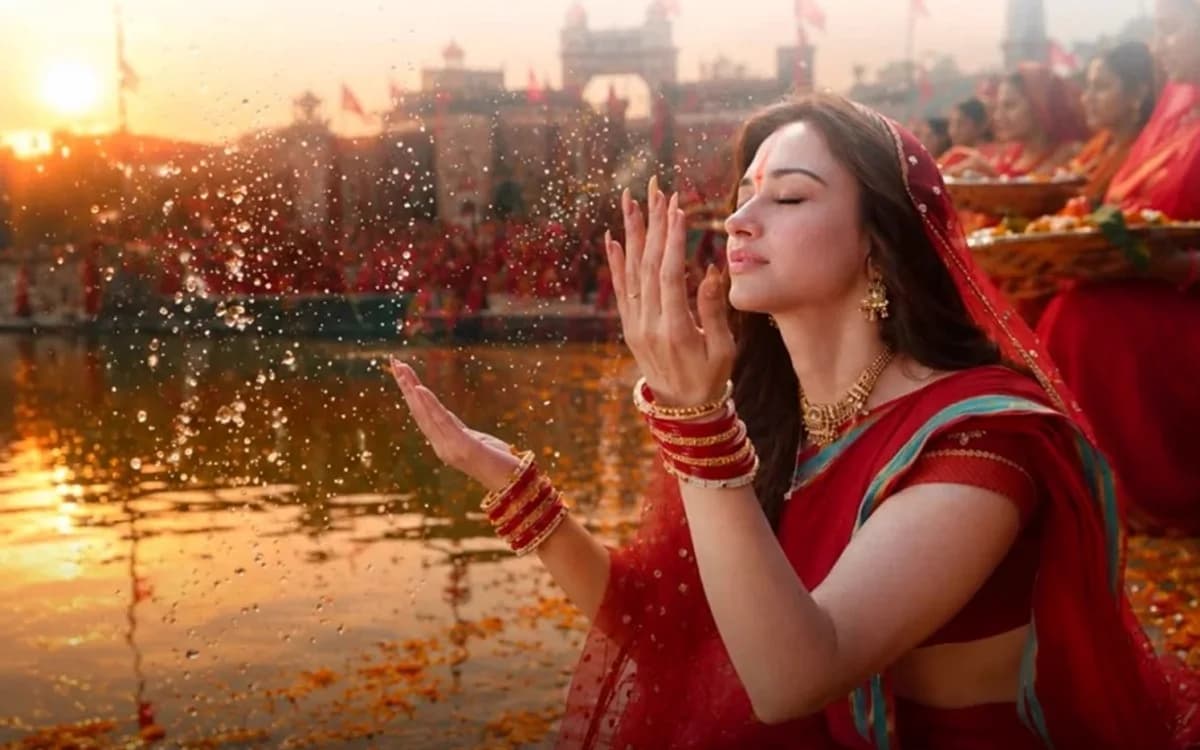 A devotee offering arghya to the sun at the ghat during Chhath Puja